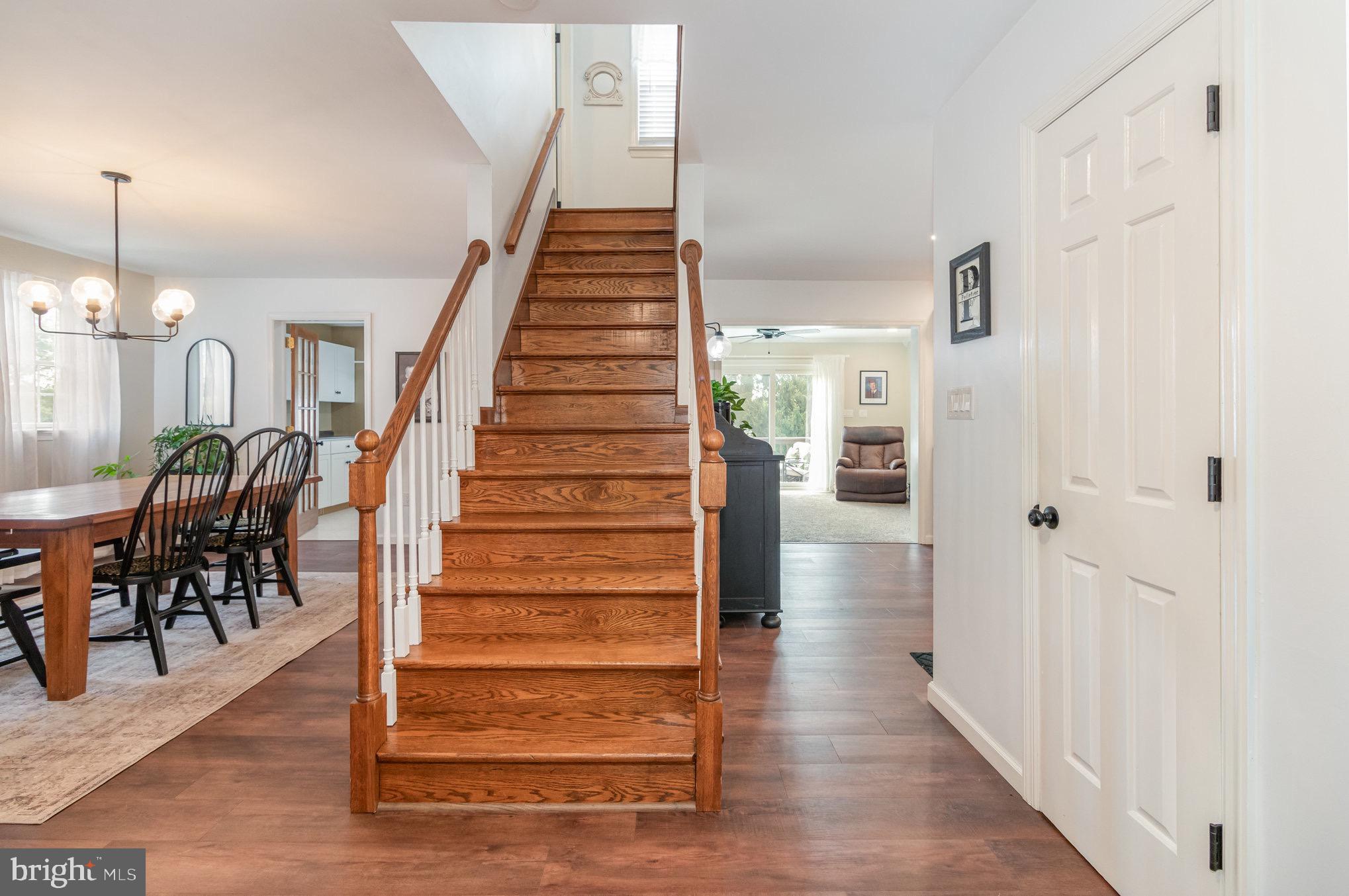 212 Weaver Drive Lititz, PA 17543 - Photo 4 of 44 a view of a hallway with wooden floor staircase and a living room