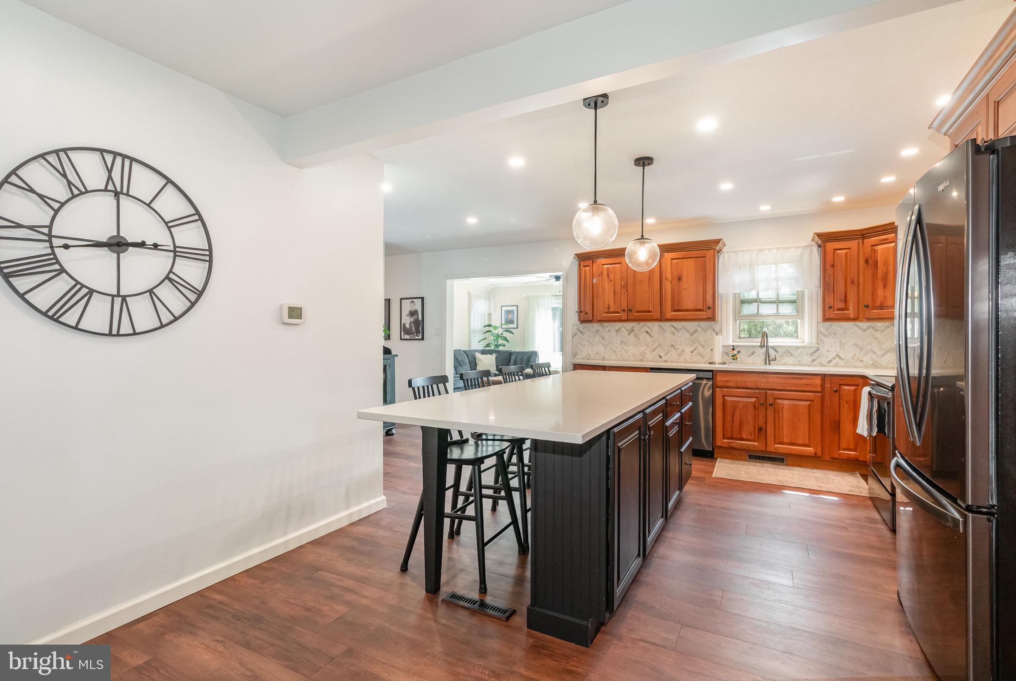 212 Weaver Drive Lititz, PA 17543 - Photo 10 of 44 a kitchen with stainless steel appliances granite countertop a stove a sink and a wooden floors