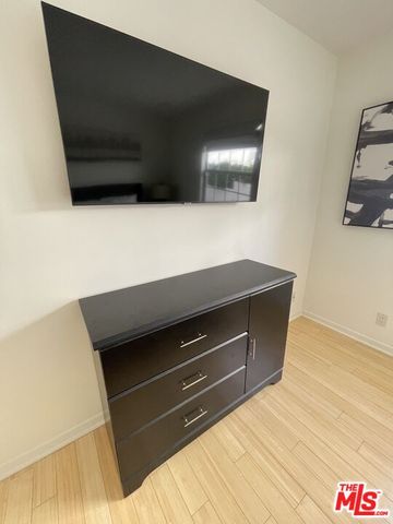 a bedroom with a bed and flat screen tv