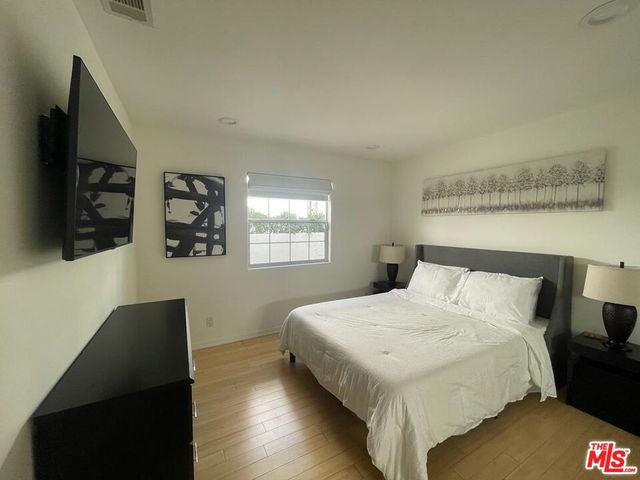 a bedroom with a bed and a flat screen tv