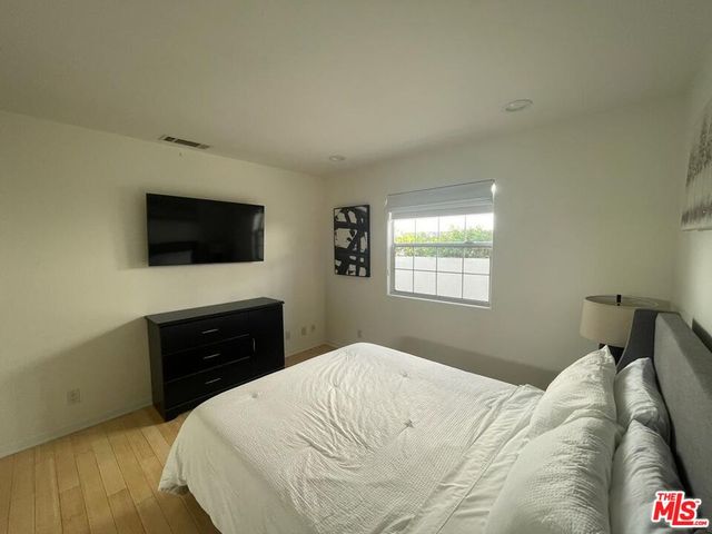 a view of a livingroom with wooden floor and a cabinet