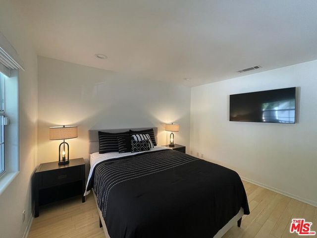 a bedroom with a bed and window