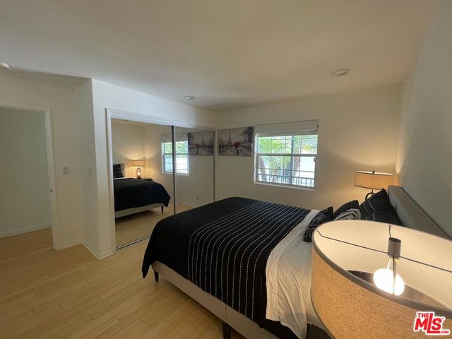 a bedroom with a bed and a desk