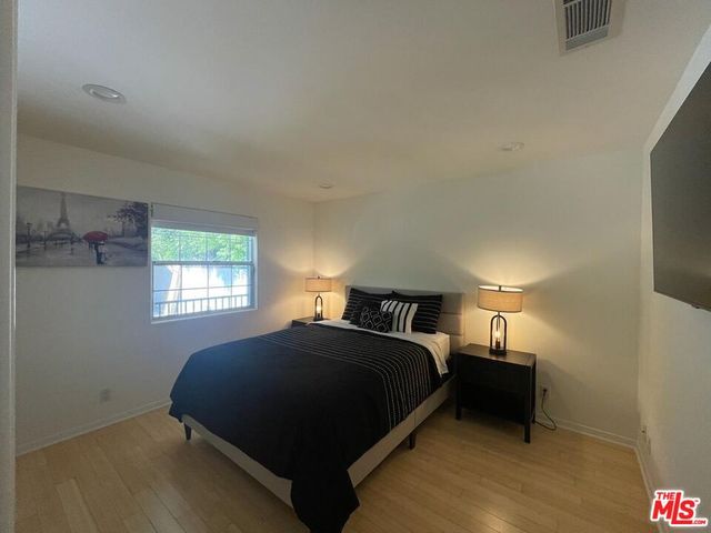 a view of a workspace with furniture and a flat screen tv