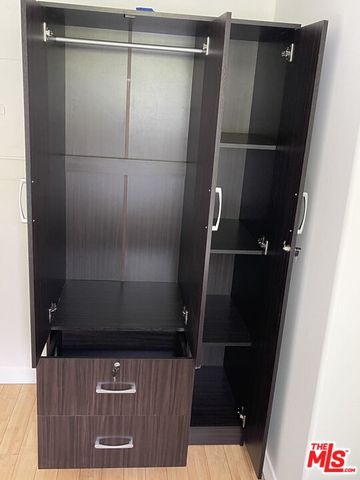 a bedroom with a bed and a chair