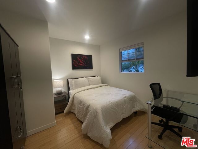 a bedroom with a bed and a wall painting