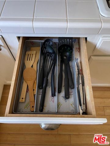 a kitchen with stainless steel appliances granite countertop white cabinets and a sink