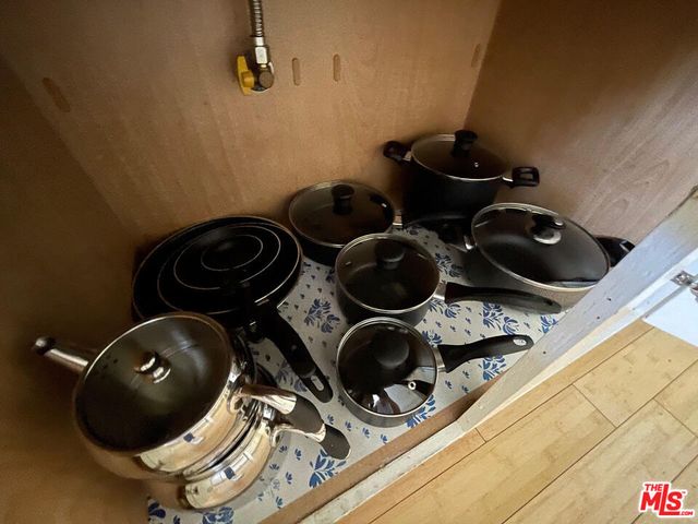 a kitchen with a stove and a white cabinets
