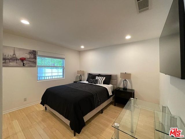 a balcony with furniture and wooden floor