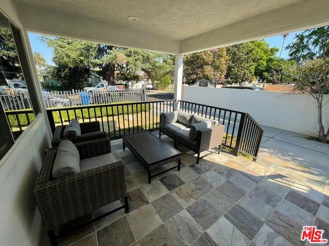 a living room with furniture a clock and white walls