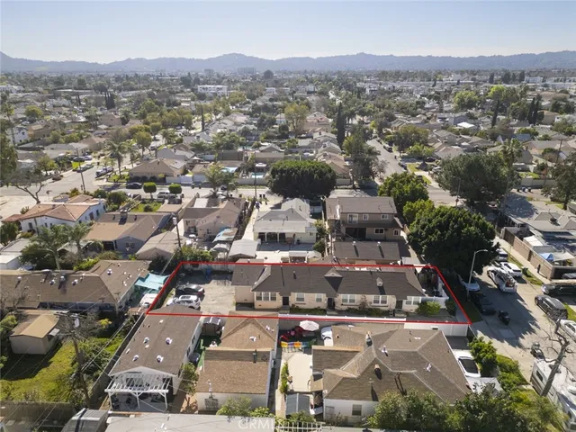 an aerial view of residential houses with outdoor space