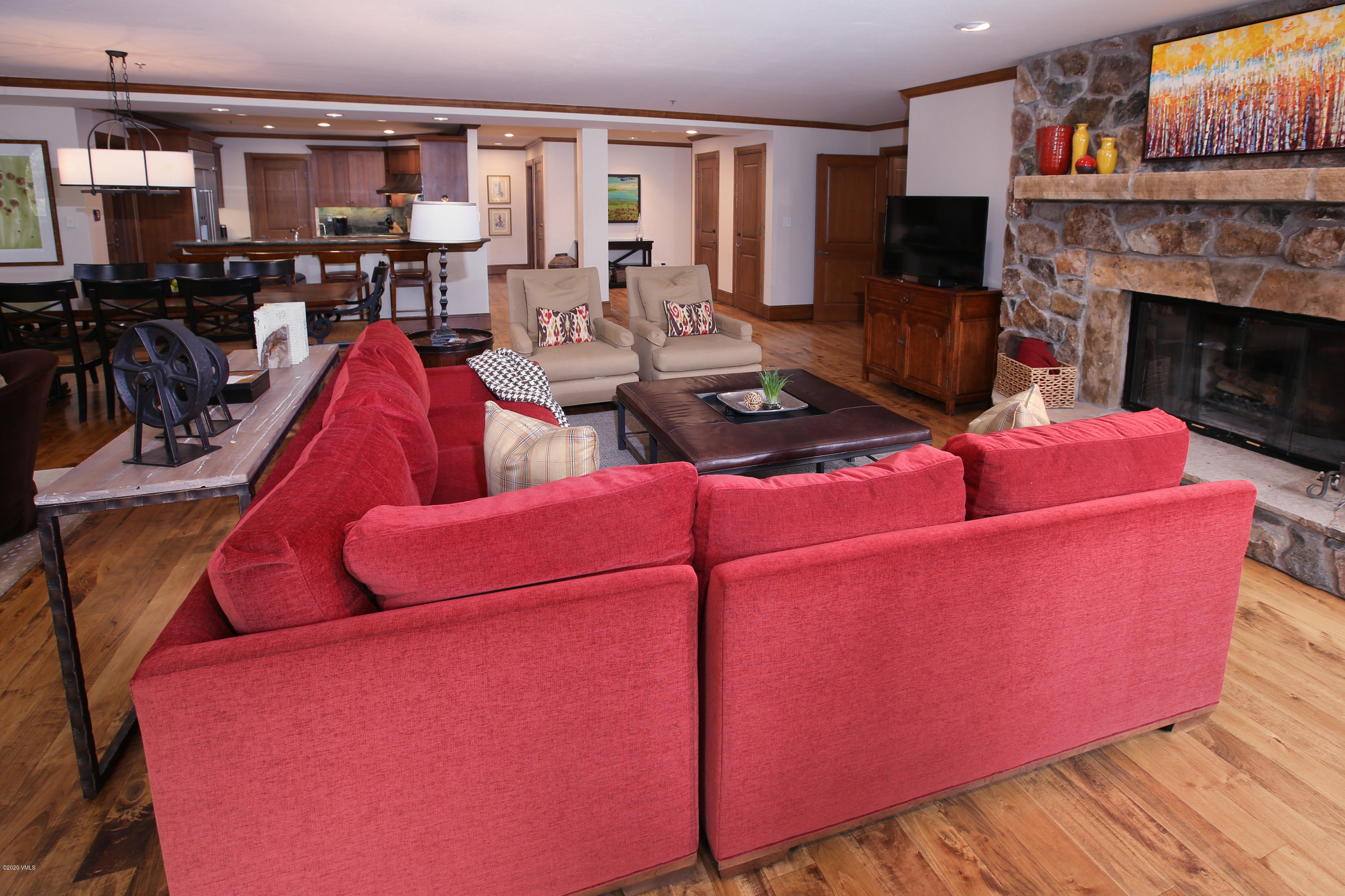 62 Highlands Lane, Unit R602 Beaver Creek, CO 81620 - Photo 11 of 30 a living room with furniture a flat screen tv and a fireplace