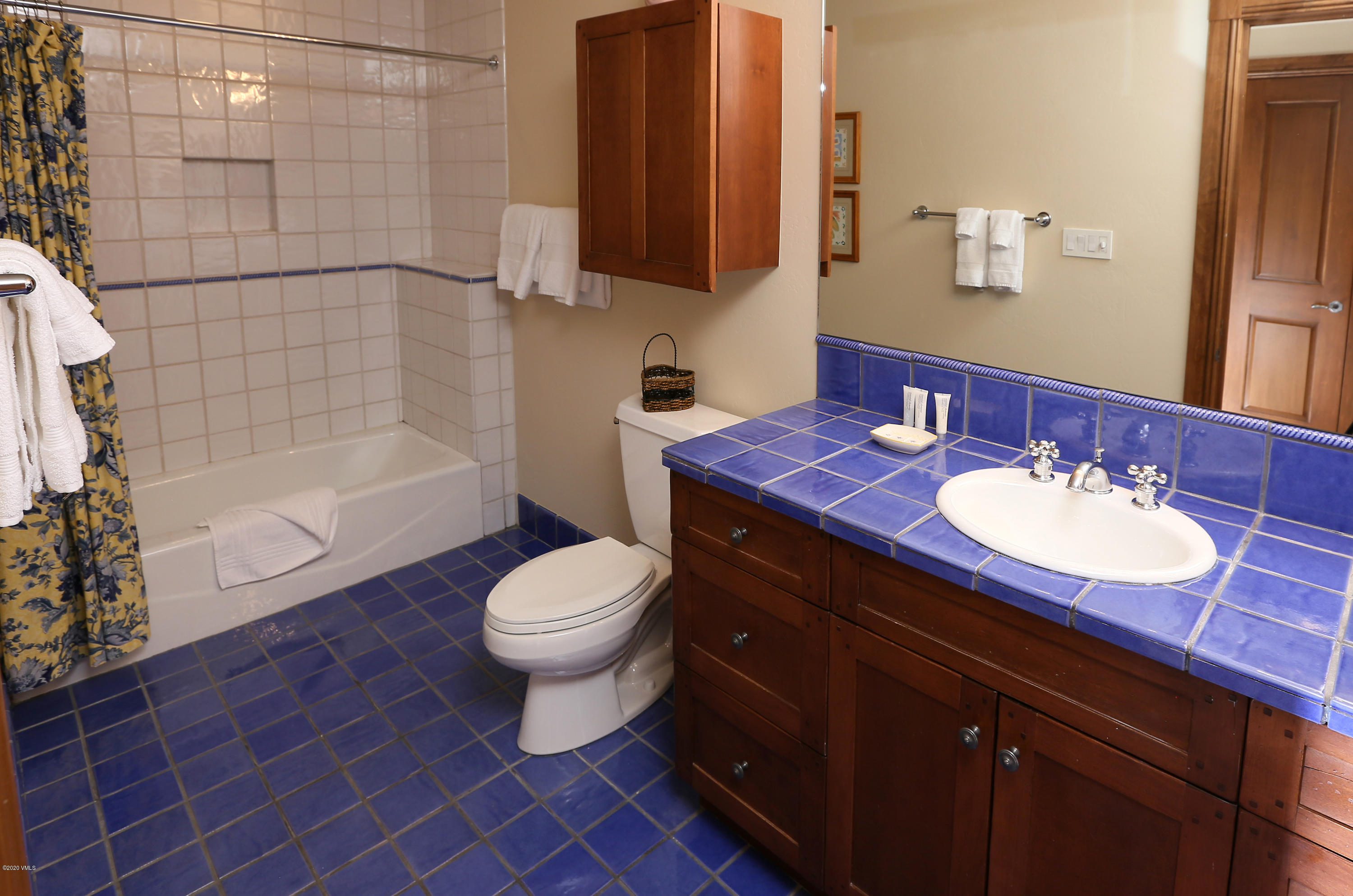 62 Highlands Lane, Unit R602 Beaver Creek, CO 81620 - Photo 19 of 30 a bathroom with a sink toilet a mirror and shower
