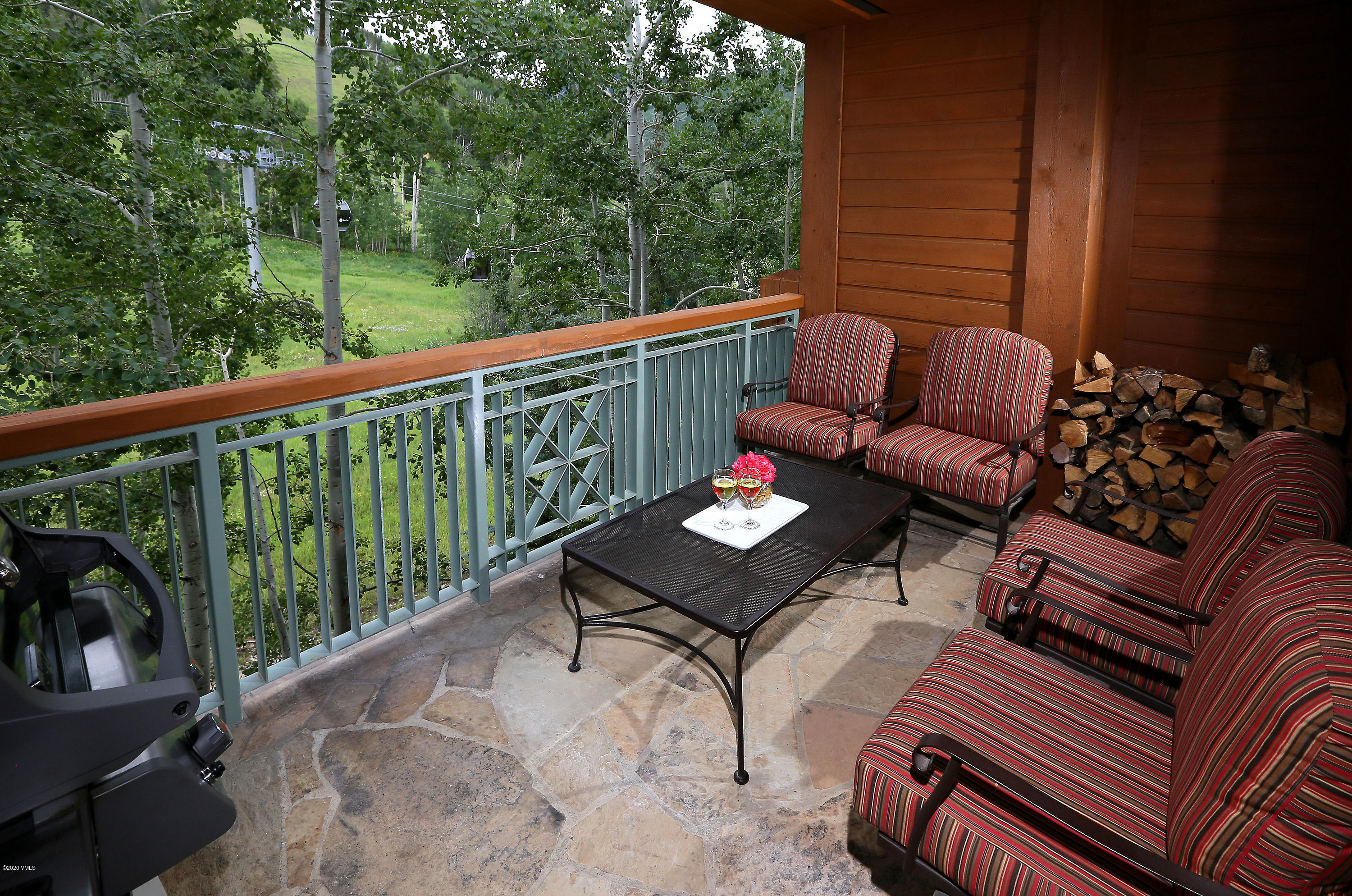 62 Highlands Lane, Unit R602 Beaver Creek, CO 81620 - Photo 23 of 30 a balcony with wooden floor and outdoor seating