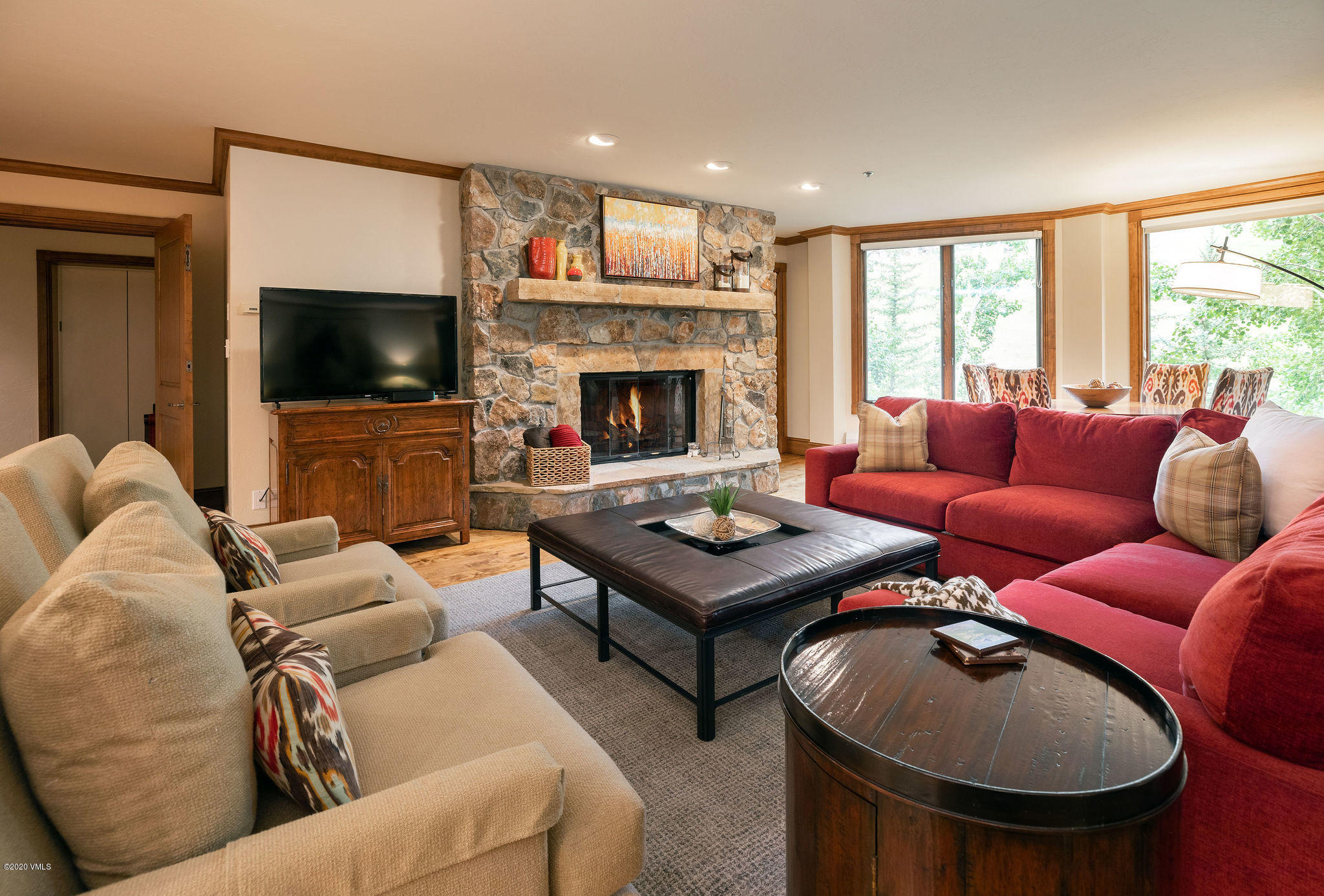 62 Highlands Lane, Unit R602 Beaver Creek, CO 81620 - Photo 6 of 30 a living room with furniture a flat screen tv and a fireplace