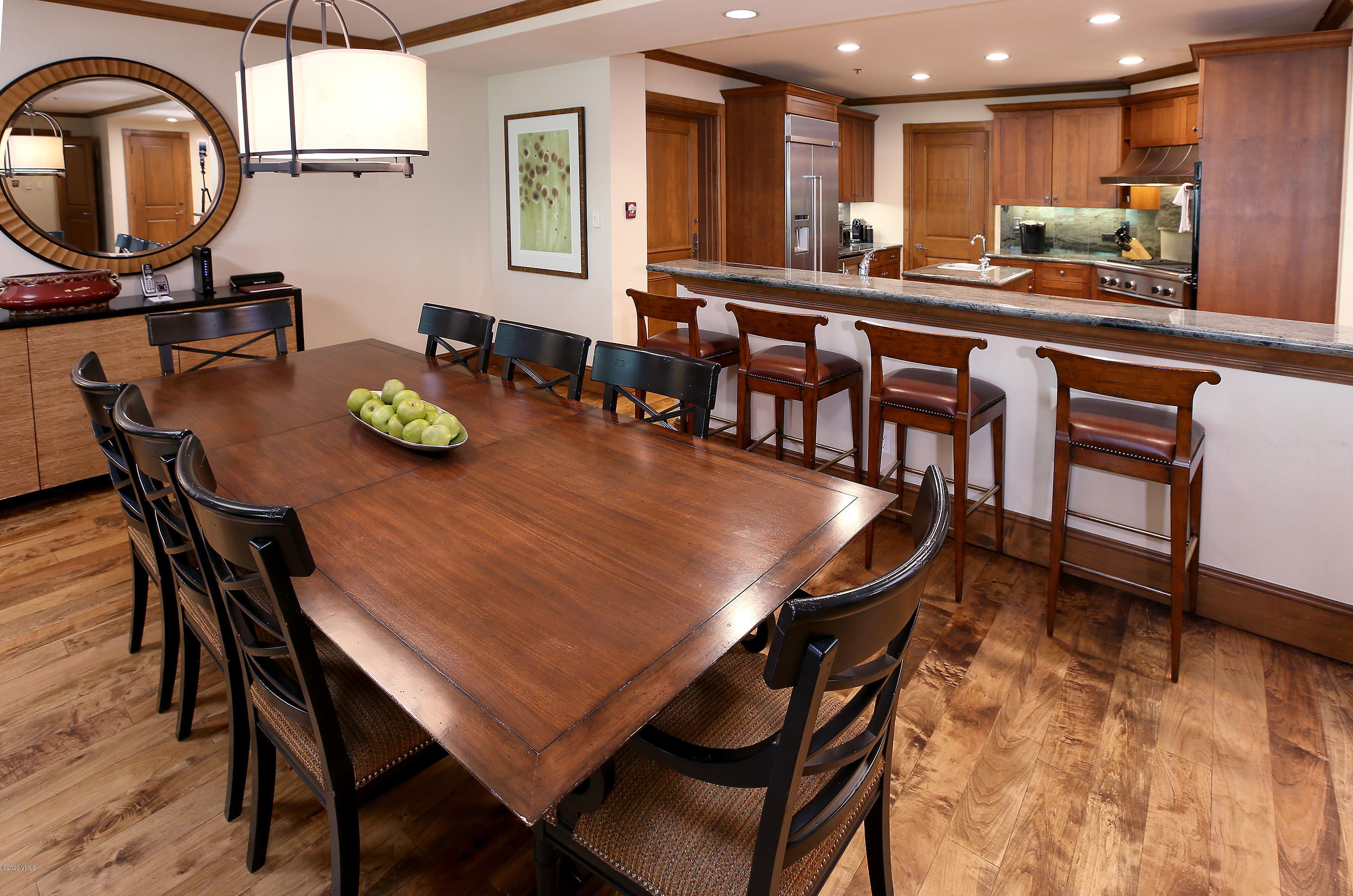 62 Highlands Lane, Unit R602 Beaver Creek, CO 81620 - Photo 7 of 30 a dining room with wooden floor a chandelier a wooden table and chairs