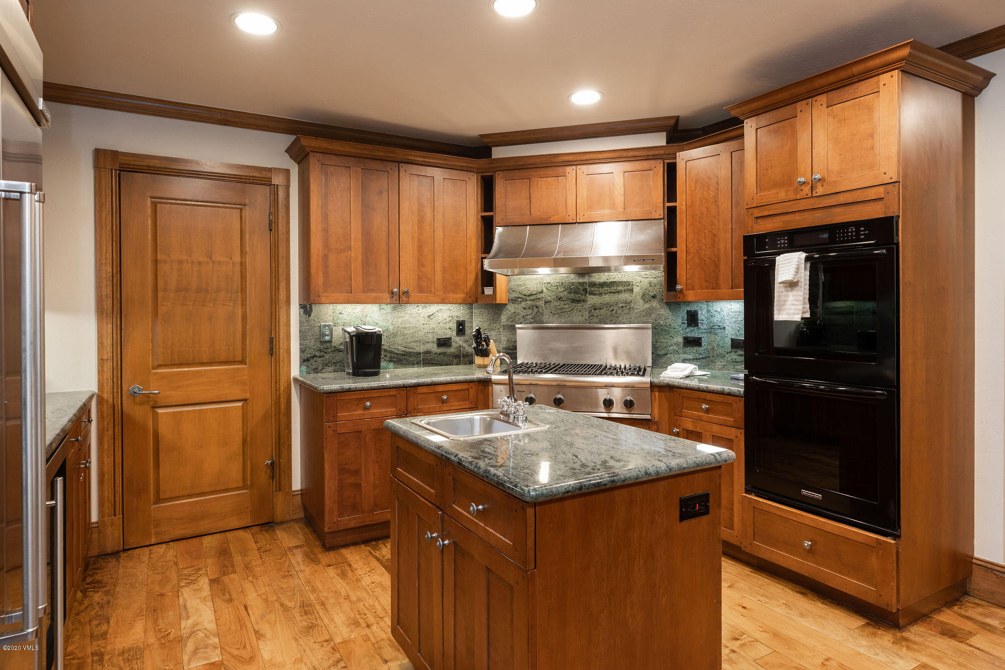 62 Highlands Lane, Unit R602 Beaver Creek, CO 81620 - Photo 9 of 30 a kitchen with a refrigerator sink and cabinets