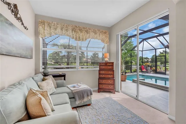 a living room with furniture a large window and a rug