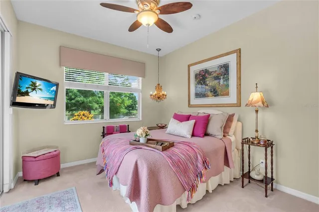 a bedroom with a bed and a painting on the wall