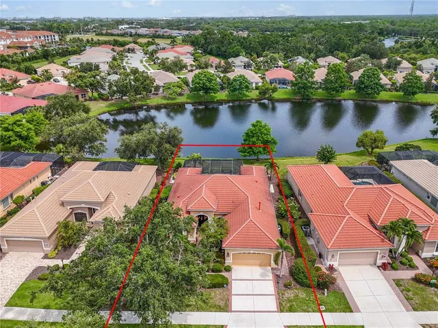an aerial view of a house with outdoor space and lake view