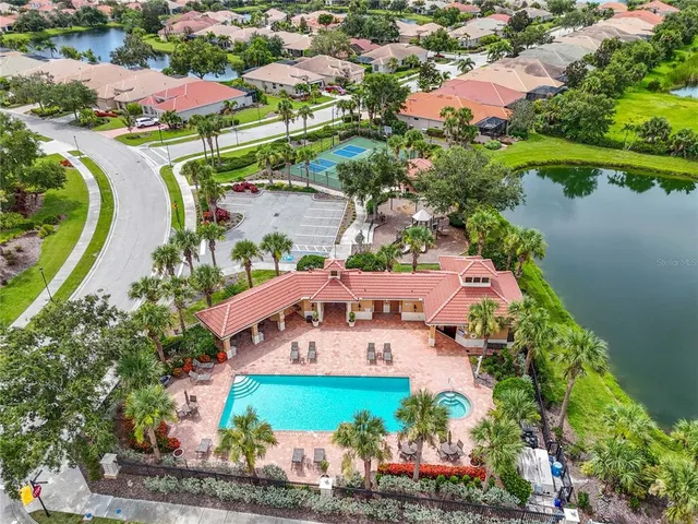 an aerial view of a house with a garden and lake view