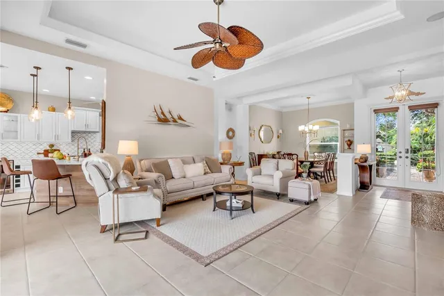 a living room with lots of furniture and a chandelier