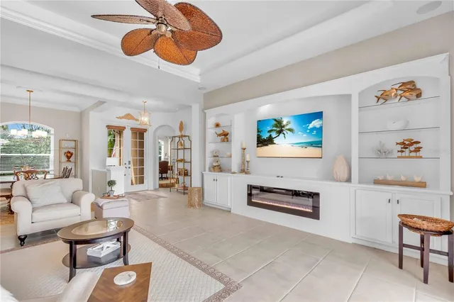 a living room with furniture and a chandelier