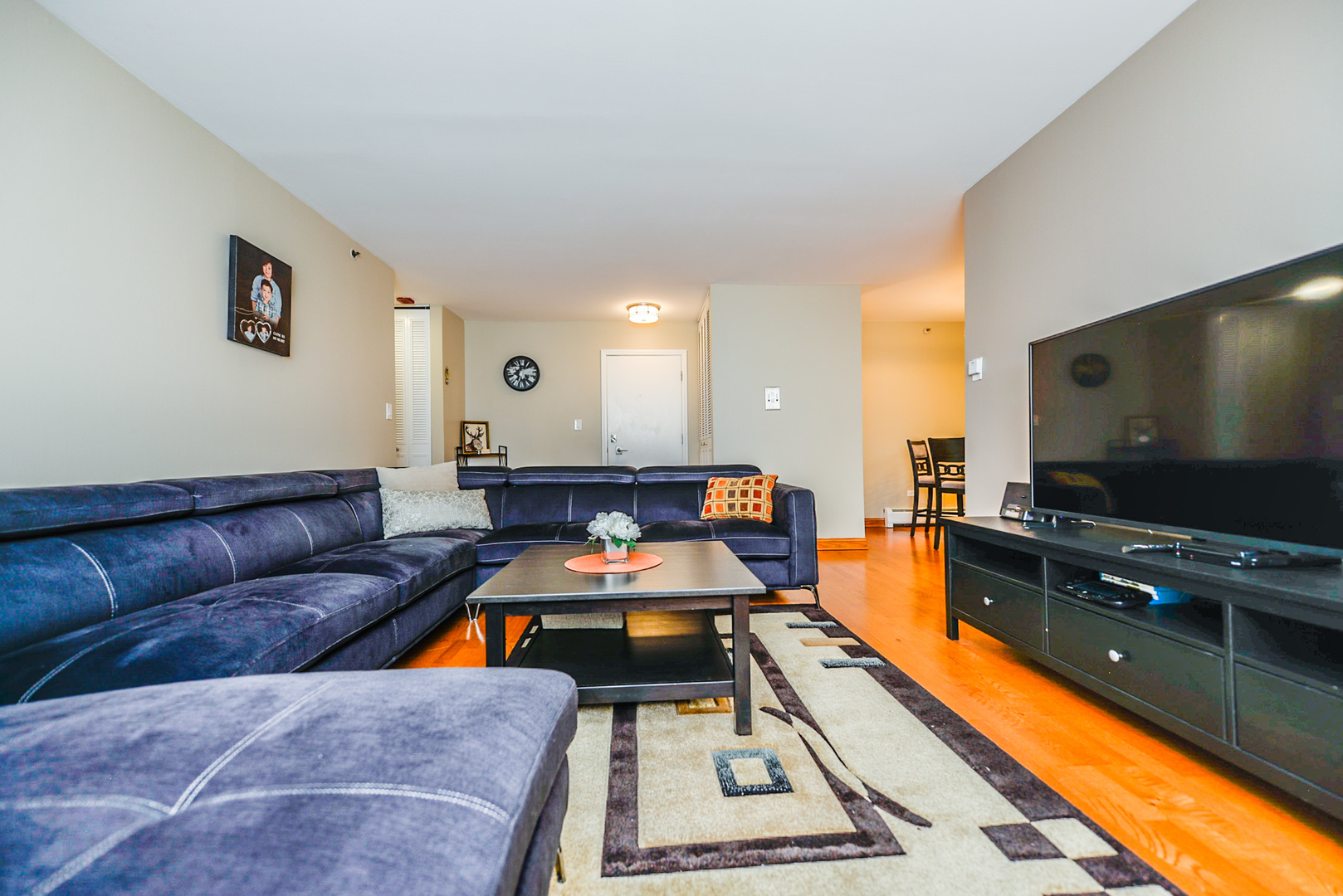 280 North Westgate Road, Unit 128 Mount Prospect, IL 60056 - Photo 16 of 29 a living room with furniture and a flat screen tv