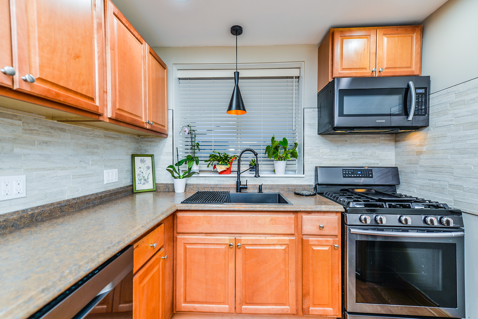 280 North Westgate Road, Unit 128 Mount Prospect, IL 60056 - Photo 9 of 29 a kitchen with stainless steel appliances granite countertop a stove a sink and a microwave