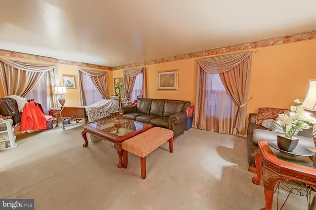 a living room with furniture a rug and a window