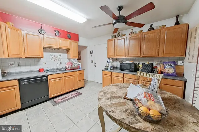 a open kitchen with stainless steel appliances granite countertop a sink dishwasher stove and cabinets