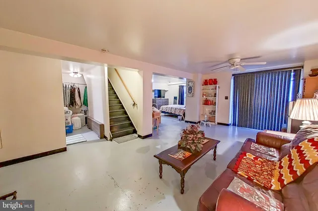 a spacious bedroom with a bed and couch