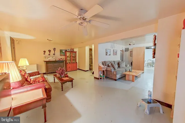 a living room with furniture and a gym machine