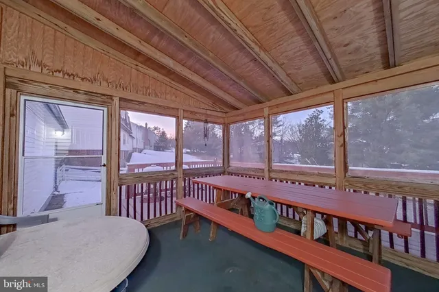 a view of a balcony with chairs and wooden floor