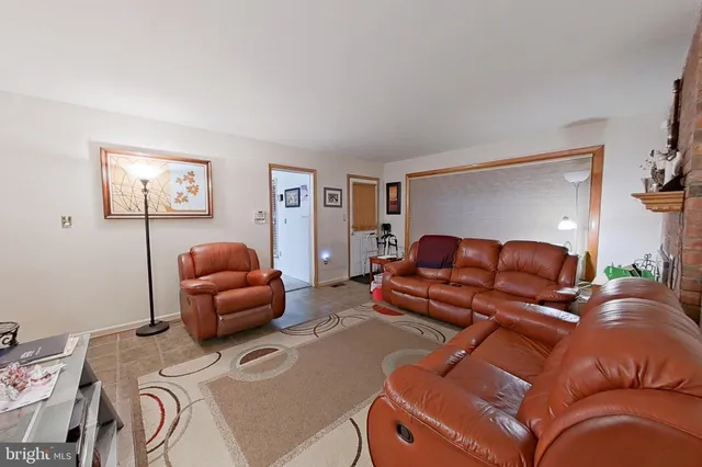 a living room with furniture a couch and dresser