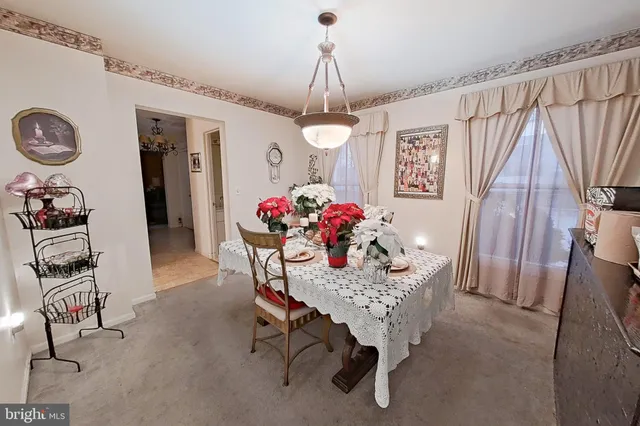 a dining room with furniture and window
