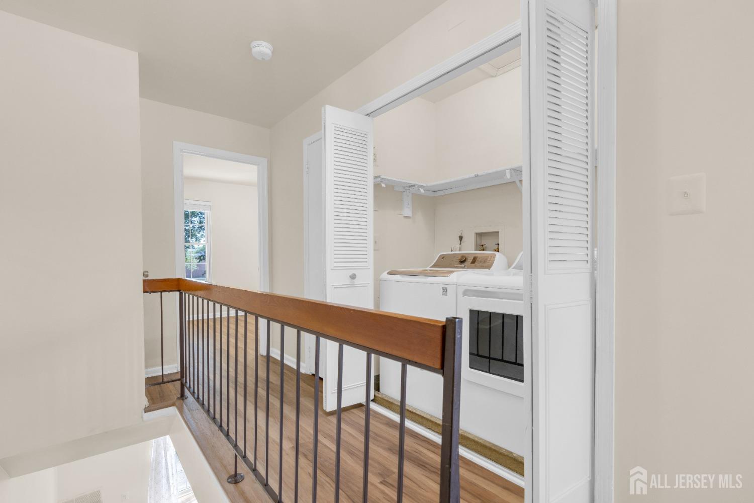 1405 Maplecrest Road Edison, NJ 08820 - Photo 20 of 33 a view of a hallway with a sink and a mirror