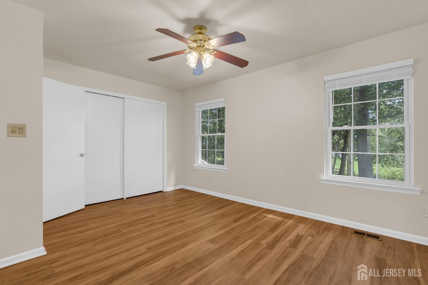 1405 Maplecrest Road Edison, NJ 08820 - Photo 22 of 33 a view of empty room with wooden floor and fan