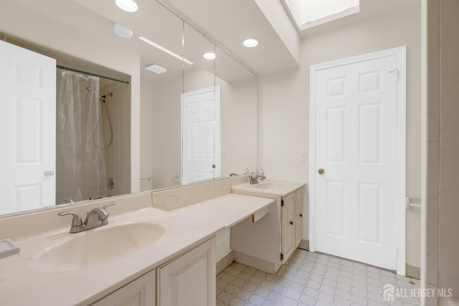 1405 Maplecrest Road Edison, NJ 08820 - Photo 24 of 33 a bathroom with a double vanity sink and a mirror