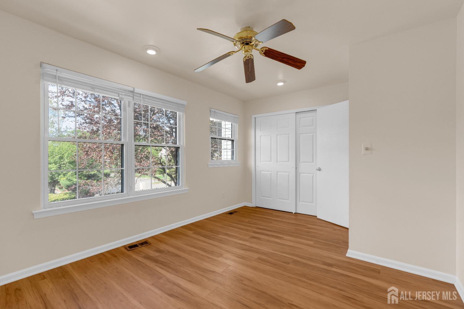 1405 Maplecrest Road Edison, NJ 08820 - Photo 28 of 33 a view of empty room with wooden floor and fan