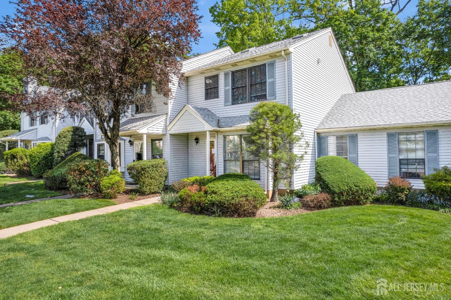 1405 Maplecrest Road Edison, NJ 08820 - Photo 3 of 33 a view of a white house next to a yard with plants and large trees