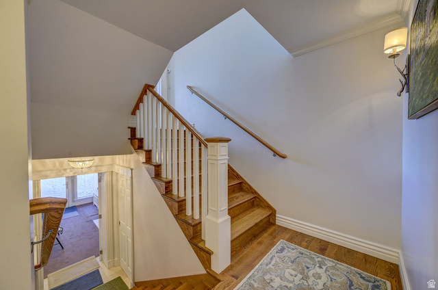 9699 Bypass Road, Unit 5 Alta, UT 84092 - Photo 12 of 54 Hardwood staircase with white balusters and a wood handrail