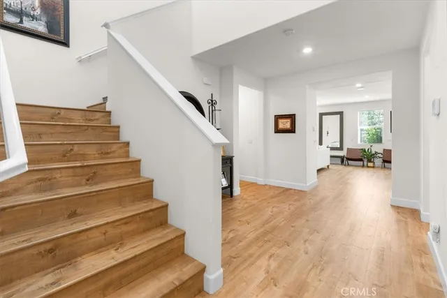 a view of entryway and hall with wooden floor