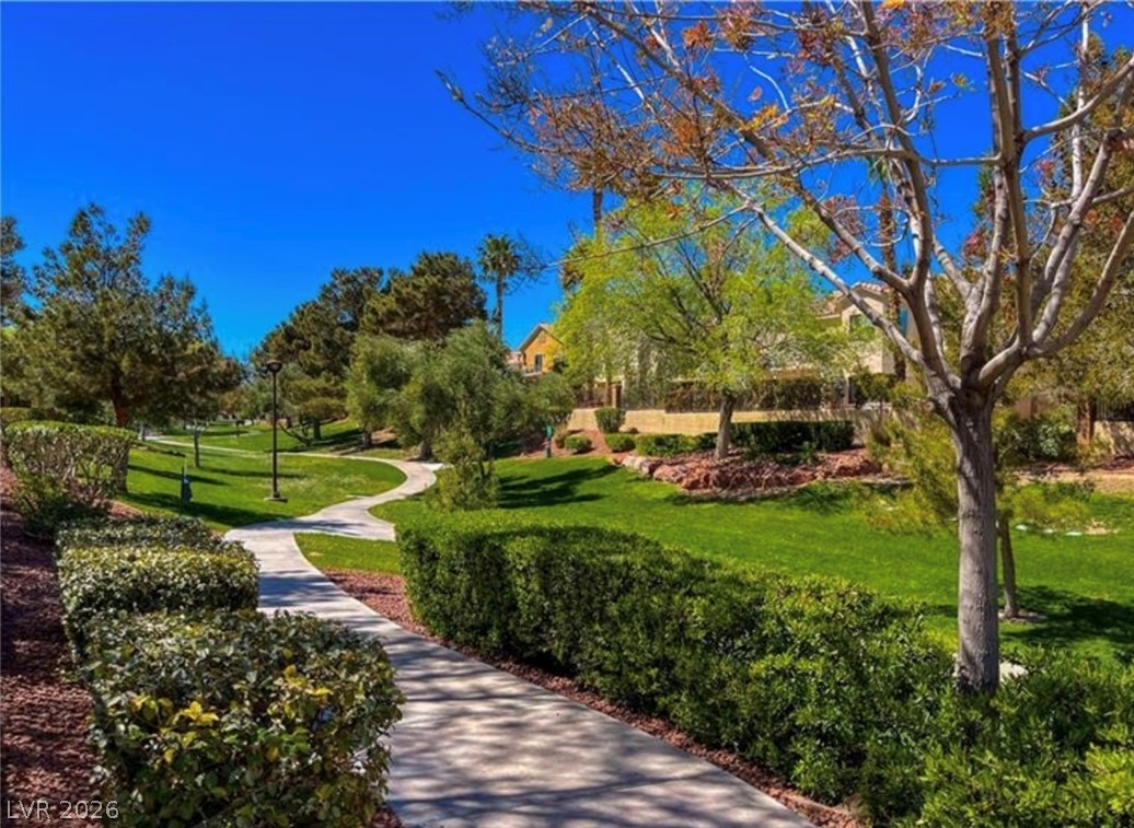 2053 Quarry Ridge Street, Unit 201 Las Vegas, NV 89117 - Photo 20 of 21 Meandering pathways lead through vibrant green spaces, offering a peaceful retreat in this landscaped community.