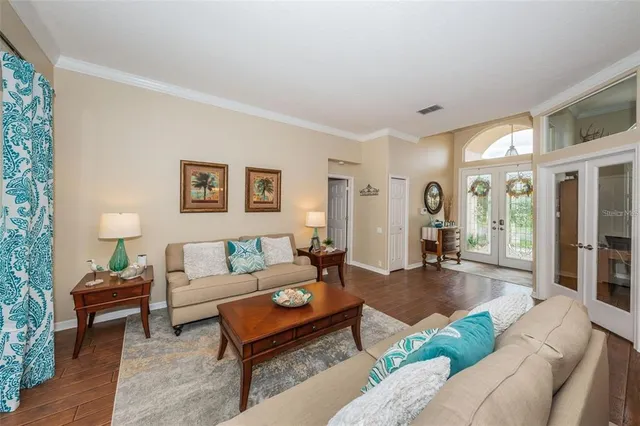 a living room with furniture and a wooden floor