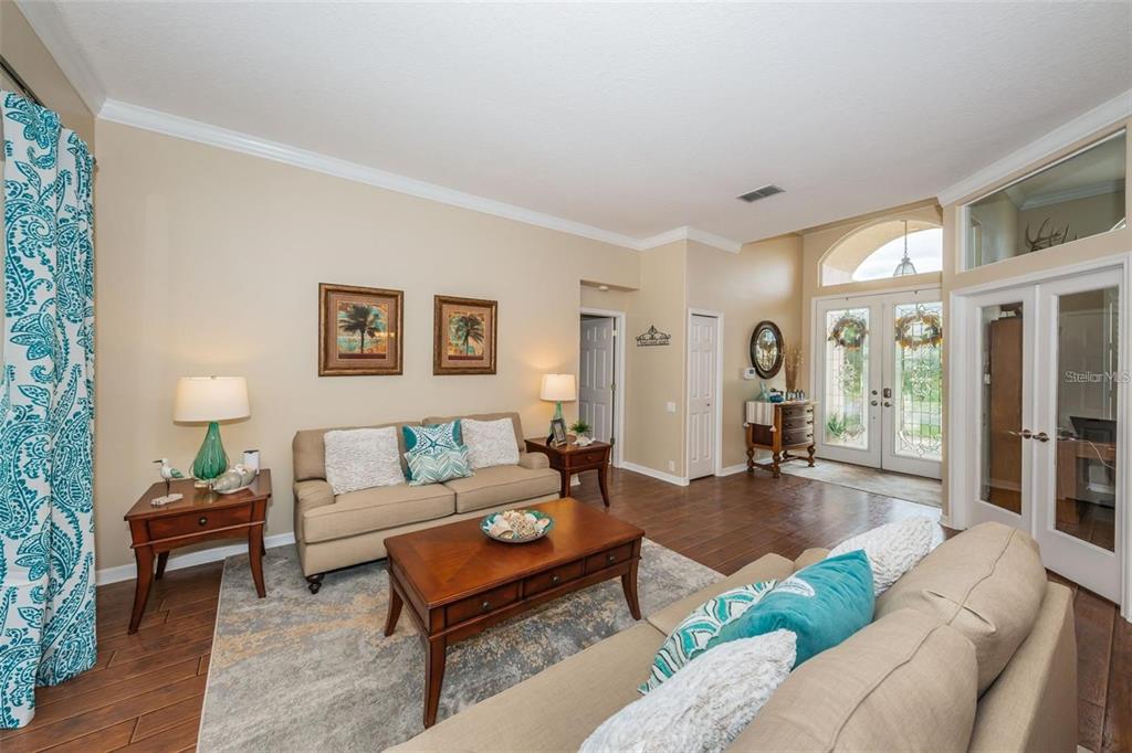 1203 Hagen Drive Trinity, FL 34655 - Photo 11 of 21 a living room with furniture and a wooden floor
