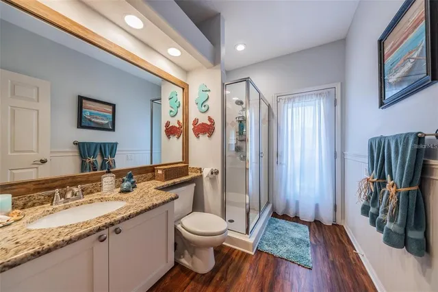 a spacious bathroom with a granite countertop sink toilet and shower
