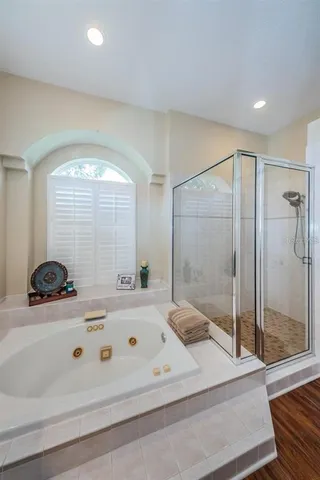 a bathroom with a sink a large mirror and a bathtub