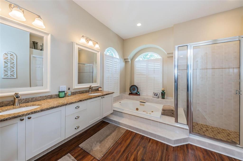 1203 Hagen Drive Trinity, FL 34655 - Photo 18 of 21 a bathroom with a double vanity sink and mirror with shower
