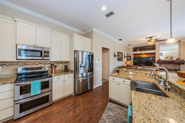 a kitchen with a stove a microwave and refrigerator